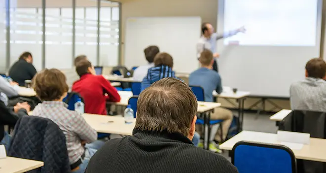 Students sitting at in a wellness training session, rear view