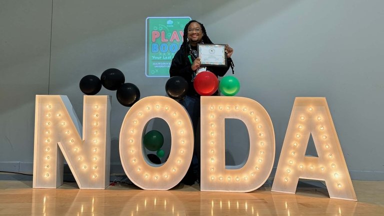 Nash McQuarters poses fr a photo with his award certificate from NODA